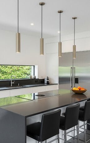 Sleek modern kitchen with island and pendant lights.